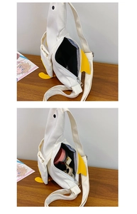 Detail view showing the spacious interior of a cute white duck canvas crossbody bag