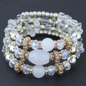 Detail of bohemian multilayer bracelet featuring crystals, cat eye beads and gold alloy spacers