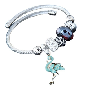 Silver beaded bangle with blue flamingo charm and marble glass beads on white background