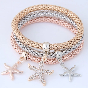 Detailed view of three starfish popcorn chain bracelets in gold, silver, and rose gold