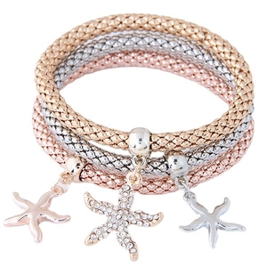 Three-piece multilayer star charm bracelet set in gold, silver, and rose gold finishes