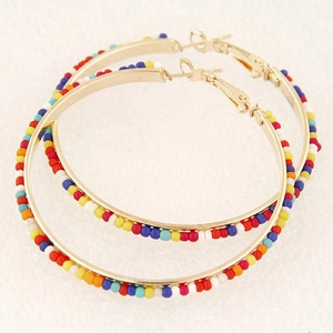 Golden bohemian hoop earrings with vibrant multi-colored beads and pin closure