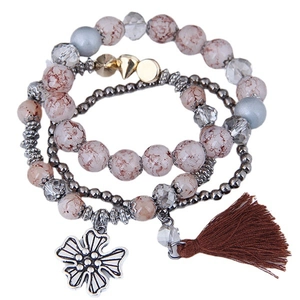 Bohemian multi-layer beaded bracelet featuring silver flower charm and brown tassel accents