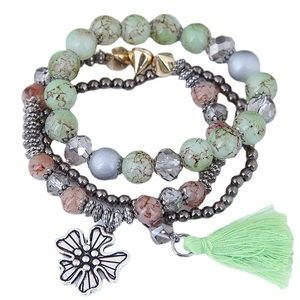 Bohemian multilayer beaded bracelet with pale green stones, silver flower charm and tassel