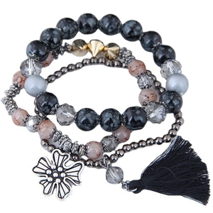 Bohemian layered beaded bracelet set with snowflake obsidian, tassels and floral charms
