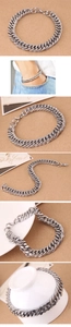 Detail view of silver Cuban link chain bracelet with lobster clasp and metal luster