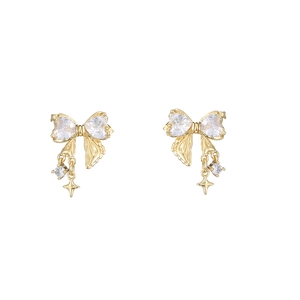 Detail of bow-shaped stud earrings featuring heart zircons and asymmetric star pendants
