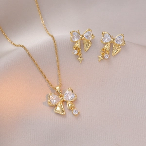 Elegant gold-plated bow jewelry set with clear cubic zirconia necklace and earrings