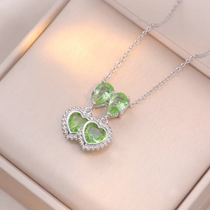 Double green heart and teardrop zircon pendant necklace in a premium beige jewelry box