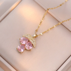 Elegant gold necklace with pink pear-cut zircon grapes and pavé diamond leaves