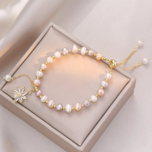 Irregular freshwater pearl bracelet with zircon sunflower pendant and gold sliding clasp