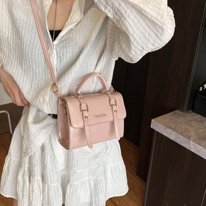 Chic light pink retro crossbody bag for women with polished leather and top handle