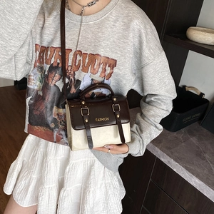 Retro two-tone crossbody bag with brown flap and fashion lettering on cream PU leather