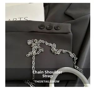Detailed macro view of high-quality silver metal chain strap on textured black fabric