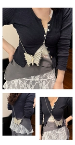 Detail of silver butterfly crossbody bag with rhinestones and snake chain strap