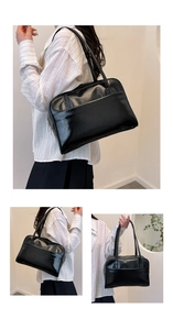 Detail of a black faux leather tote bag showing smooth texture and long shoulder straps