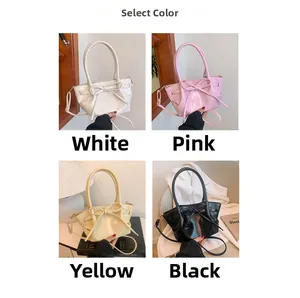 Glossy bow accent bucket bag shown in white, pink, beige, and black with detachable straps