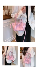 Close-up of pink patent leather handbag with bow detail and glossy mirror finish