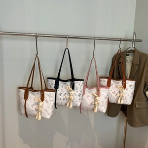 Minimalist canvas tote bag with floral prints and plush bunny charm in four colors