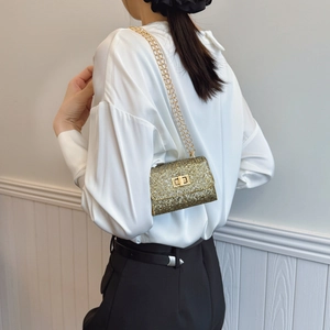 Sparkling gold rhinestone mini crossbody bag with metal chain strap and twist lock