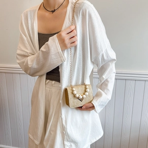 Beige straw woven crossbody bag with pearl handle and gold chain for summer