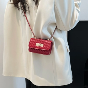 Mini red quilted faux leather handbag with silver chain strap and metal turn-lock