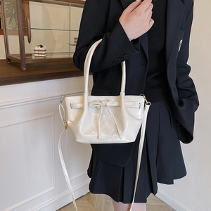 Creamy white bow bucket bag with pleated design and elegant top handles for women