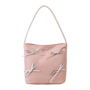 Pink bucket bag with silver bows and long shoulder strap for summer fashion style