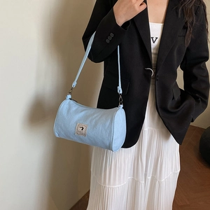 Minimalist light blue cylinder pillow bag with cute cartoon patch on casual blazer outfit