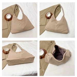 Detail view of khaki hobo tote bag featuring golden metal studs and spacious interior
