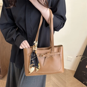 Large caramel brown leather tote bag with silk scarf accent for urban commuting style