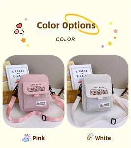 Detail view of pink and white canvas crossbody bags with cute Capybara cartoon prints