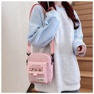 Detail of pink canvas crossbody bag featuring cute Capybara print and adjustable strap