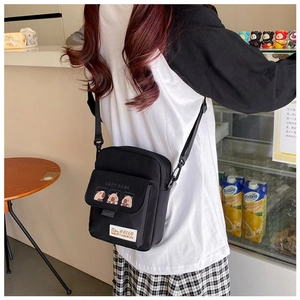 Cute black canvas crossbody bag featuring Capybara cartoon prints and adjustable strap