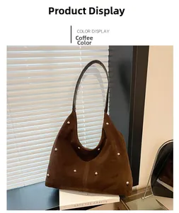 Detailed view of coffee brown suede tote bag with decorative golden metal rivets