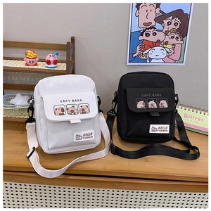 Detail of white and black canvas crossbody bags with cute Capybara cartoon prints