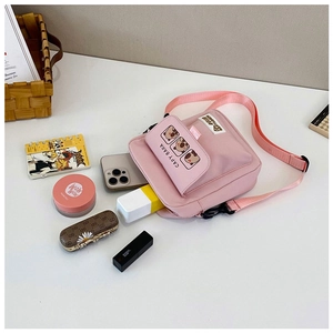 Pink Capybara canvas crossbody bag shown with phone and makeup to display capacity
