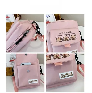 Pink Capybara mini crossbody bag detail view with front pocket and adjustable strap