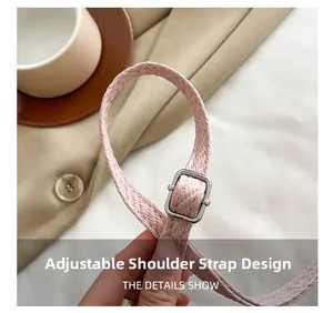 Macro view of adjustable pink woven shoulder strap with silver metal buckle for handbag