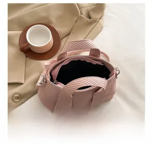 Close-up of pink corduroy bucket bag interior space and textured fabric details