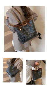 Detail view of large retro tote bag with grey circle patterns and brown leather handles