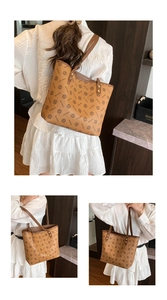 Detail of vintage printed tote bag featuring brown leather straps and rivet accents