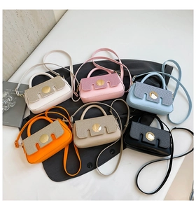 Detailed overhead view of mini leather handbags in six vibrant colors with metallic buckles