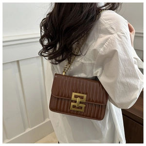 Dark brown pleated chain shoulder bag shown on model with gold geometric lock