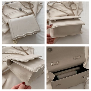 Detailed views of beige leather crossbody bag with wavy flap and adjustable chain strap