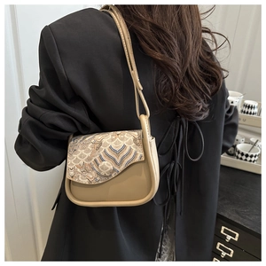Close-up of retro shoulder bag with traditional Chinese embroidery and wavy patterns