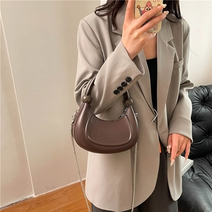 Brown crescent moon shoulder bag with silver chain strap and smooth leather finish