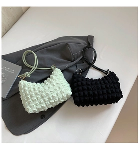 Detail of soft bubble texture and knotted shoulder strap on pleated hobo bags