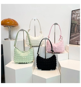 Detail of hobo bags in four colors with distinctive textured bubble pleat fabric design