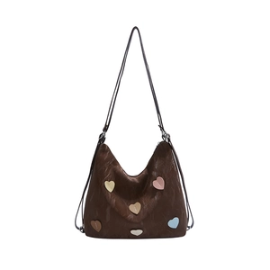 Brown faux leather tote bag with colorful heart patches and pleated texture